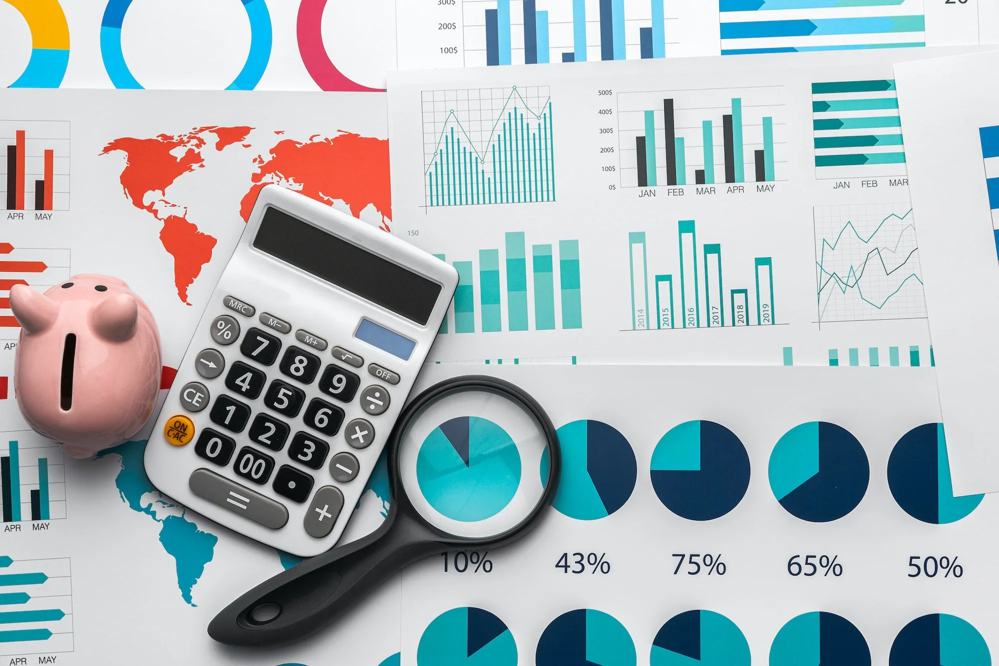 Business graphs paper and calculator on table