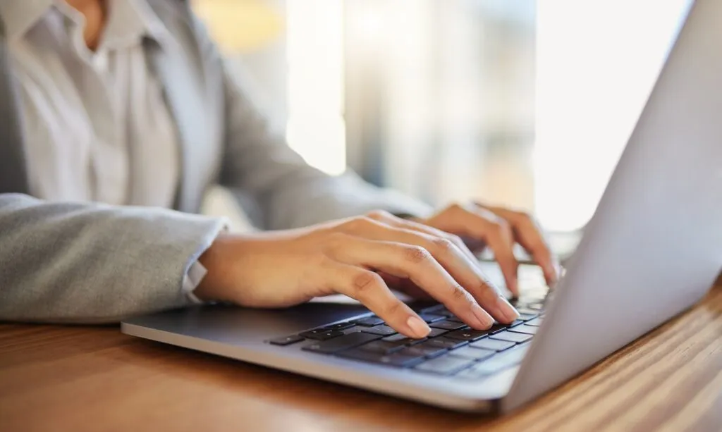 Laptop, email and worker typing for marketing, advertising or documents planning in corporate offic